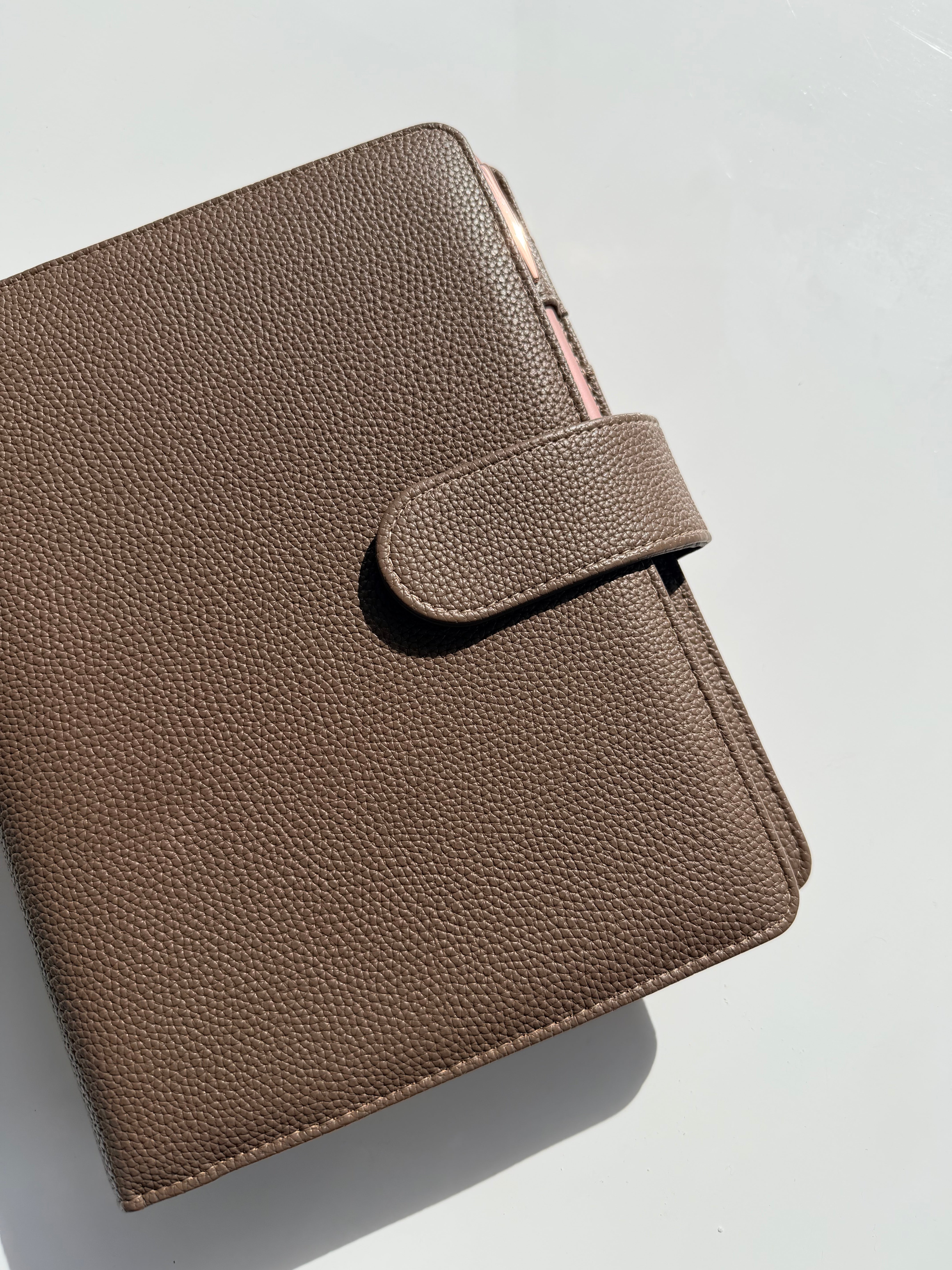 Chocolate vegan leather discbound A5 planner with a pen loop and clip closure
